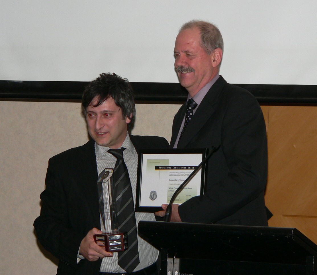 Harry Rakintzis (left) presents the 2009 Outstanding Achievement Award to Sergeant Barry Woolven, South Australia Police.