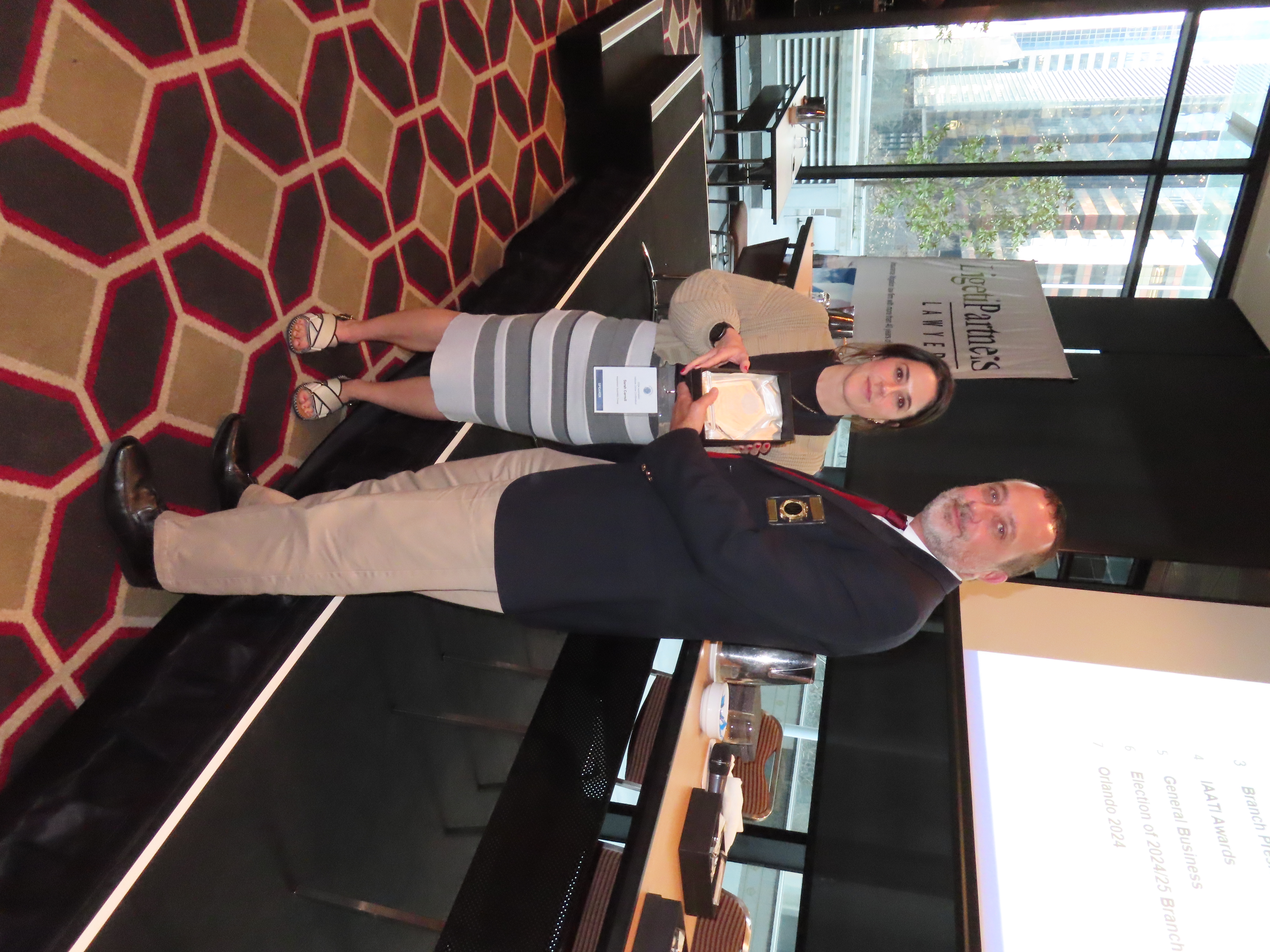 Sarah Carroll, Fraud Data Intelligence Analyst at IAG, receiving the 2024 Forensic and Supporting Services Award from IAATI President, Nathan McGanty.