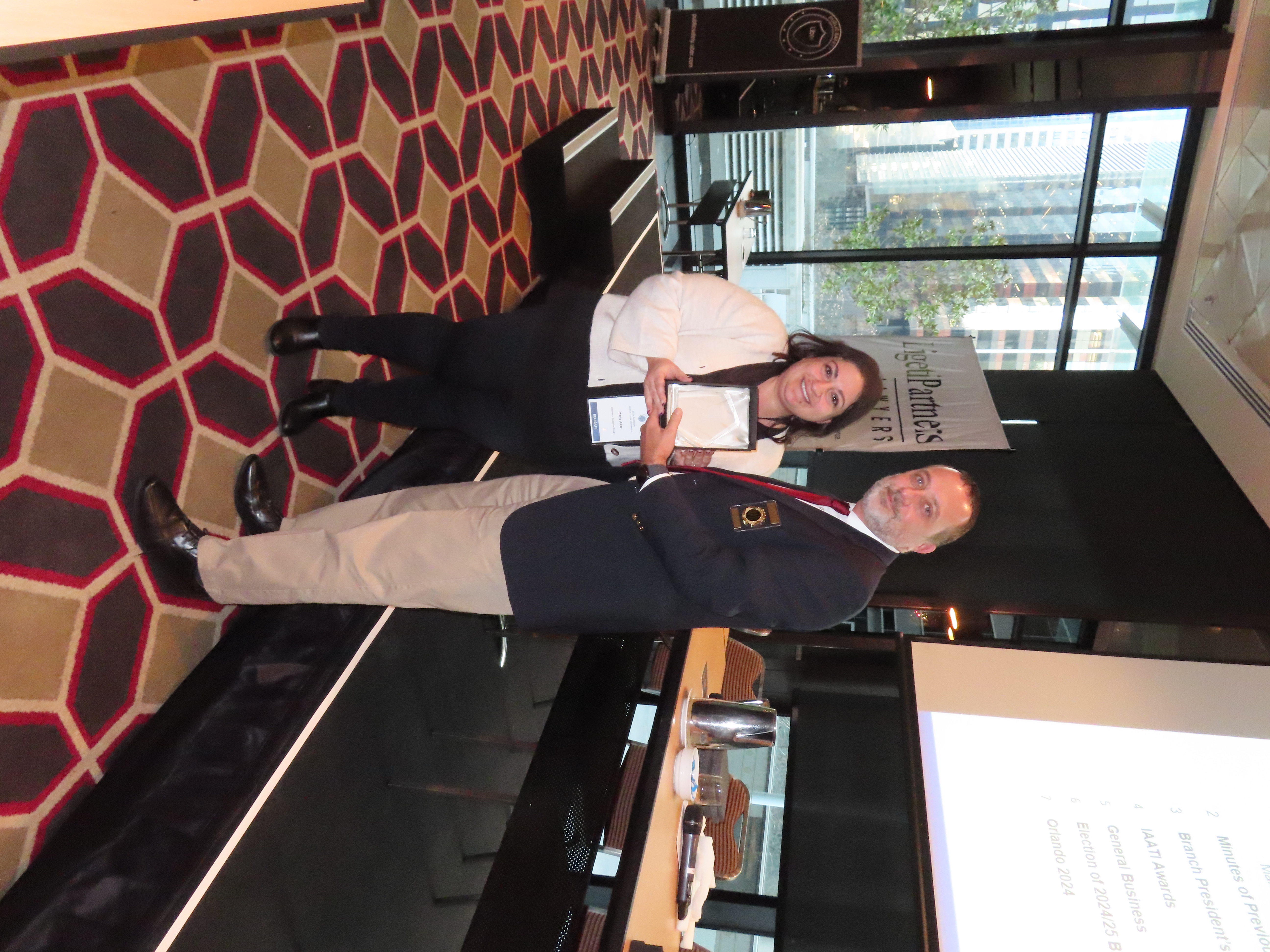 Marie Azar accepting the 2024 Insurance Industry Investigation of the Year Award from International IAATI President Nathan McGanty, on behalf of the Operation Herring Team at IAG.