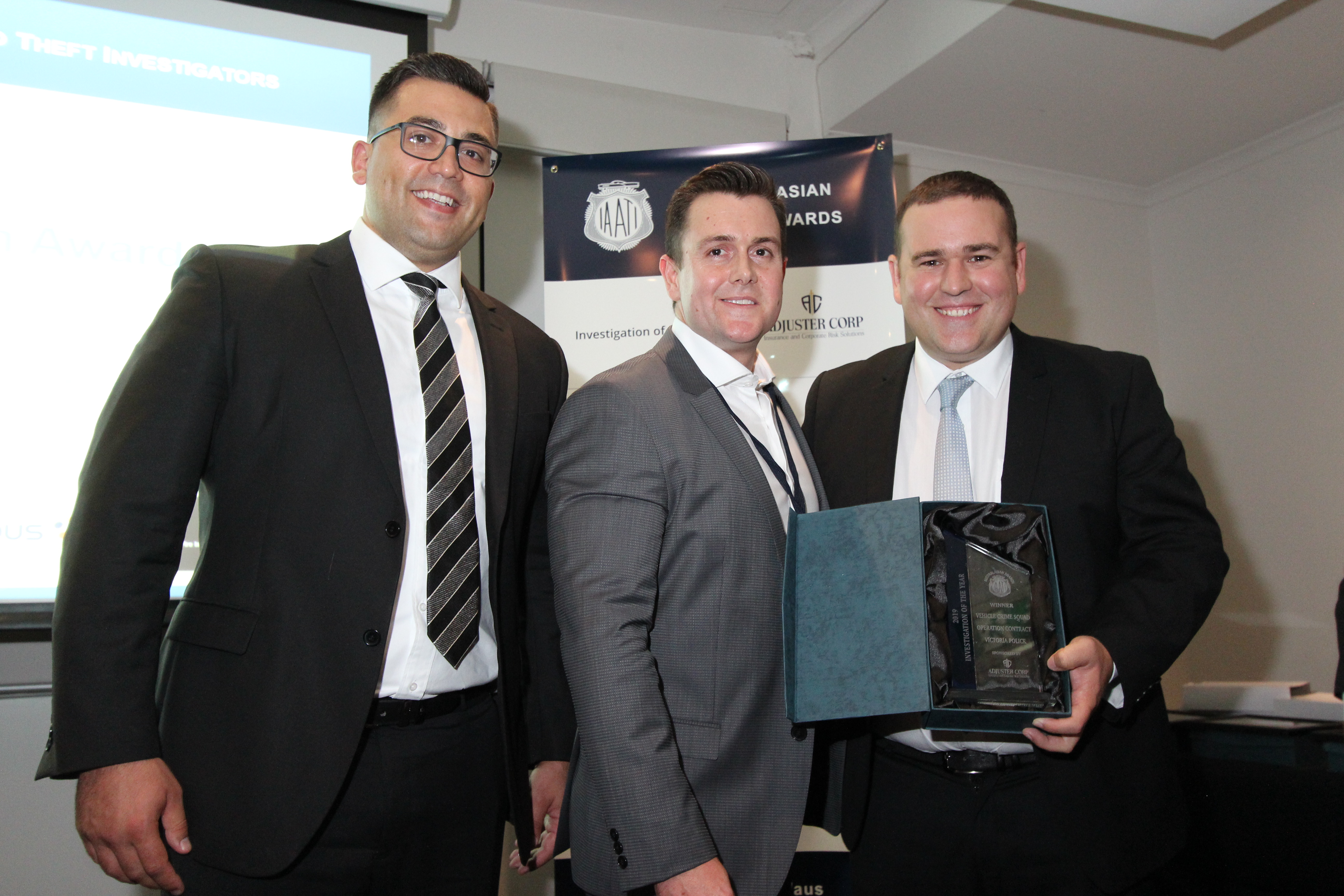 Operation Contract, Victoria Police - 2019 AB Investigation of the Year - Daniel Burke (middle), from award sponsor AdjusterCorp, presents the trophy to Det. Senior Constable Daniel Beard from Victoria Police